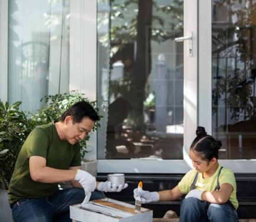 kid and father coloring with tinted windows in back