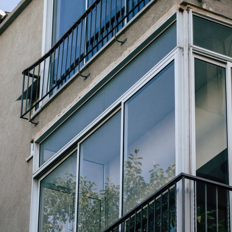 home with tall balcony and tinted windows